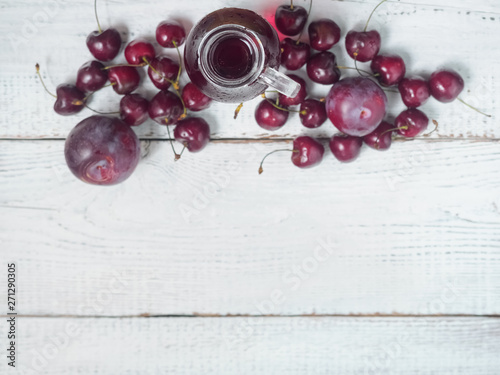 Delicious summer  lemonade with ice,cherry, e on wooden background.  Glass with cold, fresh drink or coctail on white table. Background with drink, top view