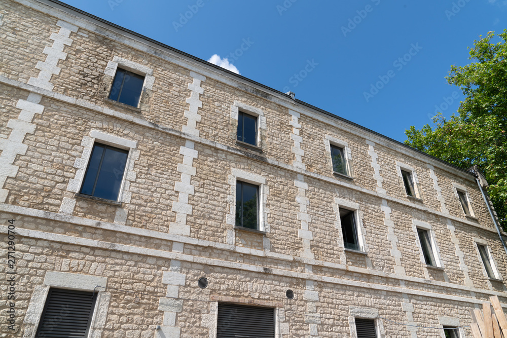 facade of a stone building with windows