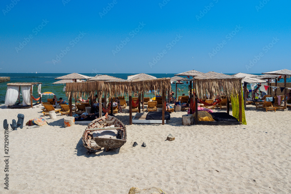 Vintage sun loungers with canopy on beach in Odessa, Ukraine