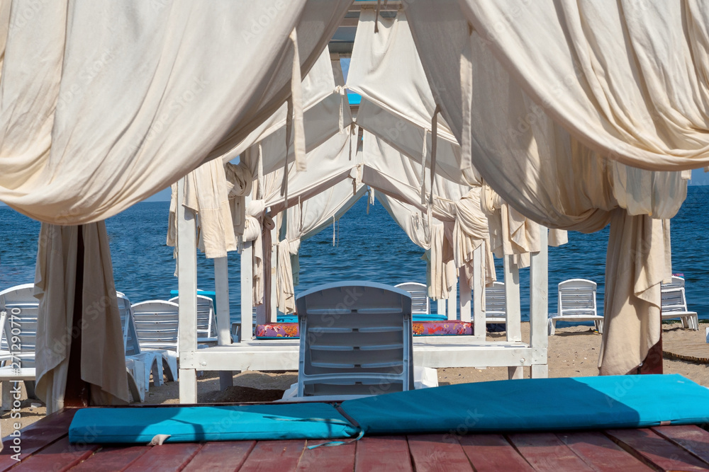 Sun loungers with canopy on beach in Odessa, Ukraine