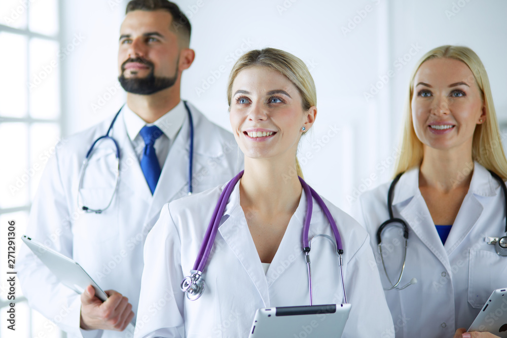 Smiling doctors all standing together as they work Smiling doctors all standing together as they work