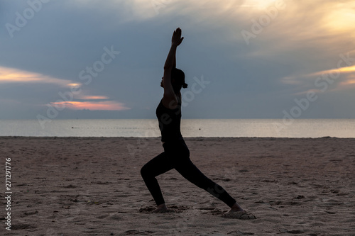 practise yoga on the beach in early morning
