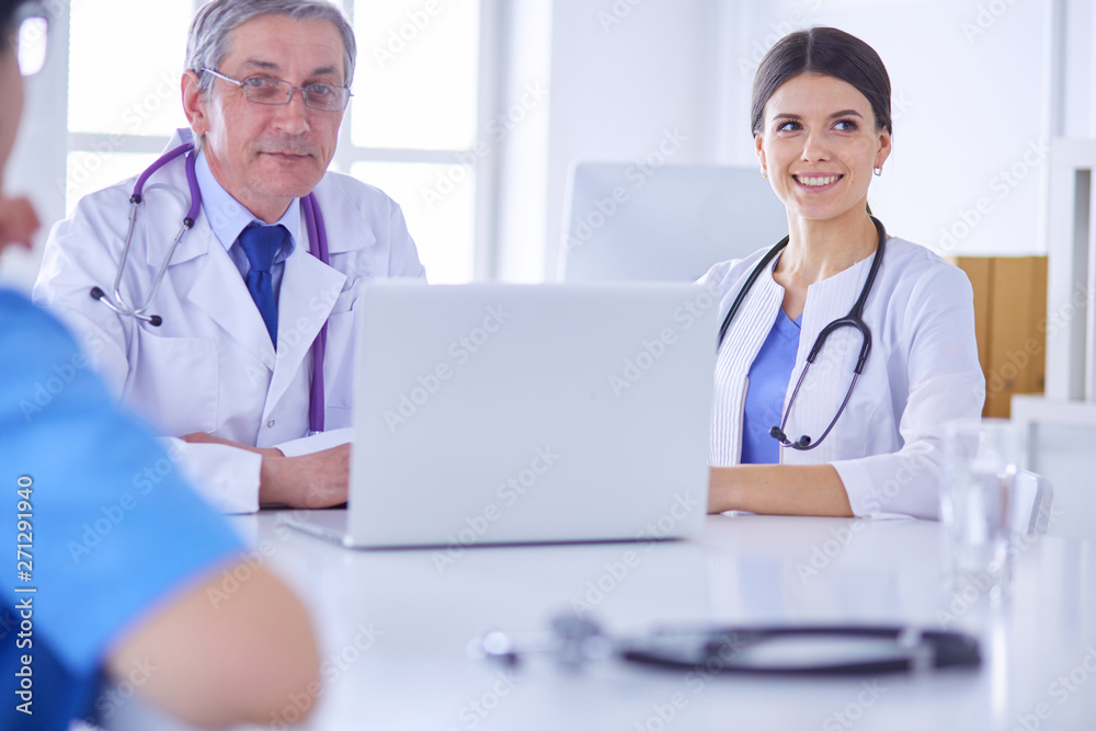 Serious medical team working in a bright office Serious medical team working in a bright office