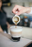 Moka caffe making by barista. Hand and blurry background