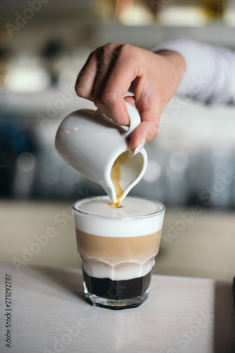 Moka caffe making by barista. Hand and blurry background
