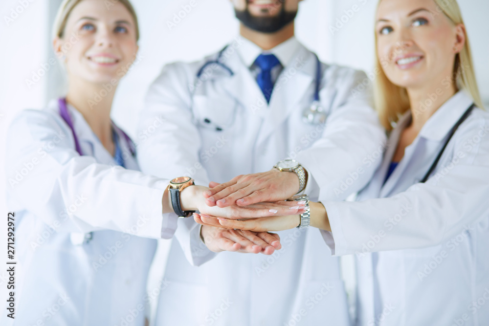 Doctors and nurses in a medical team stacking hands Doctors and nurses in a medical team stacking hands