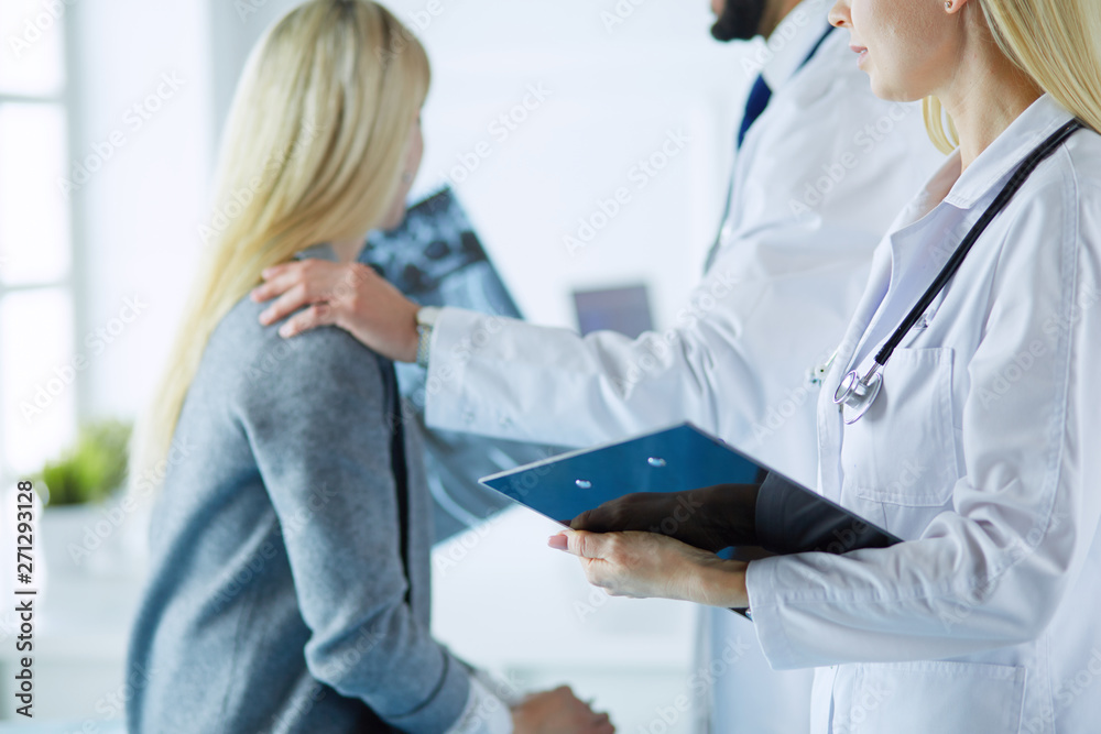 Doctor and patient discussing scan results in diagnostic center Doctor and patient discussing scan results in diagnostic center