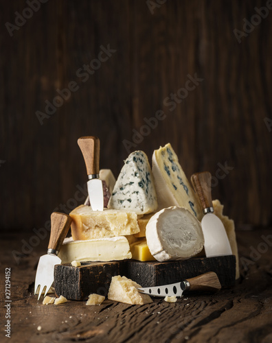фотографія Assortment of different cheese types on wooden background