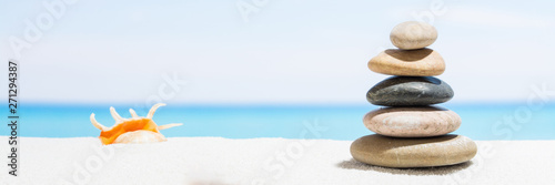 Relaxing in the tropical beach  with white sand and stack of stones. Background for banner