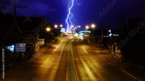 Lightning storm over the bridge and street long exposure and zoom time lapse video. photo