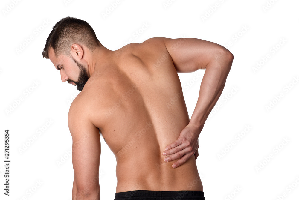 Young man with back pain. The athlete clings to a sore back. Man hurt his back. Sports medicine concept