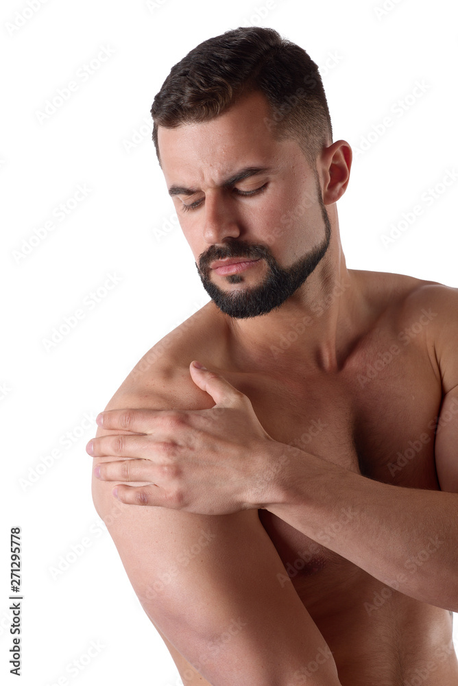 Muscular strong man with shoulder pain, isolated on white background. Sportsman holds his sore shoulder Muscular strong man with shoulder pain, isolated on white background. Sportsman holds his sore shoulder