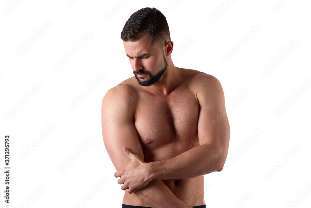 Muscular strong man with shoulder pain, isolated on white background. Sportsman holds his sore shoulder