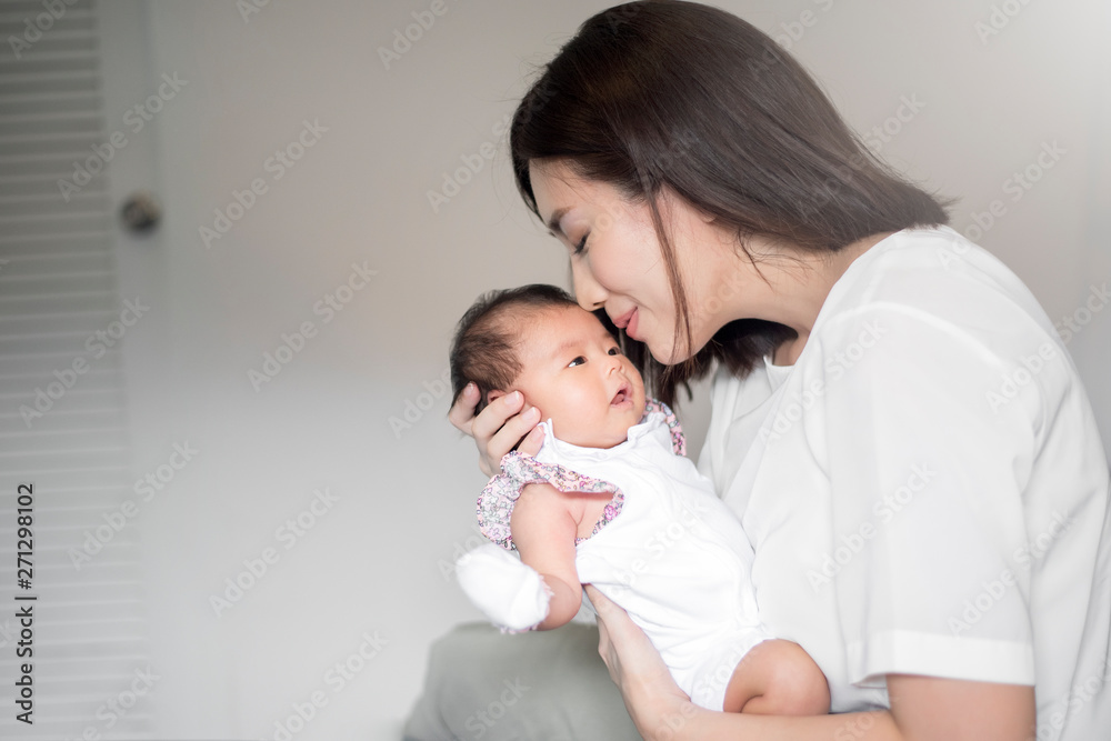 Beautiful woman holding a newborn baby in her arms Beautiful woman holding a newborn baby in her arms