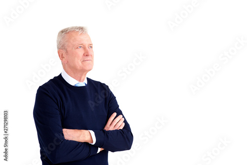 Elderly man portrait while standing with arms crossed at isolated white background