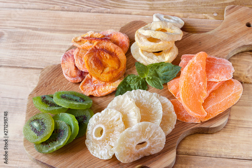 Fototapeta Naklejka Na Ścianę i Meble -  Mixed dried fruits on the wooden board.