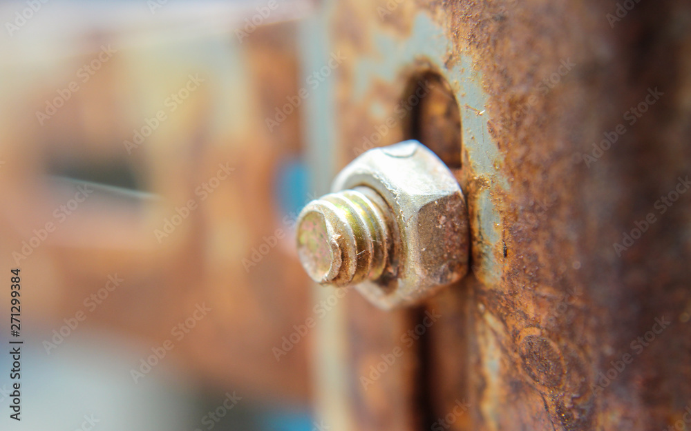 Old rust nut on steel pole, building steel material outdoors