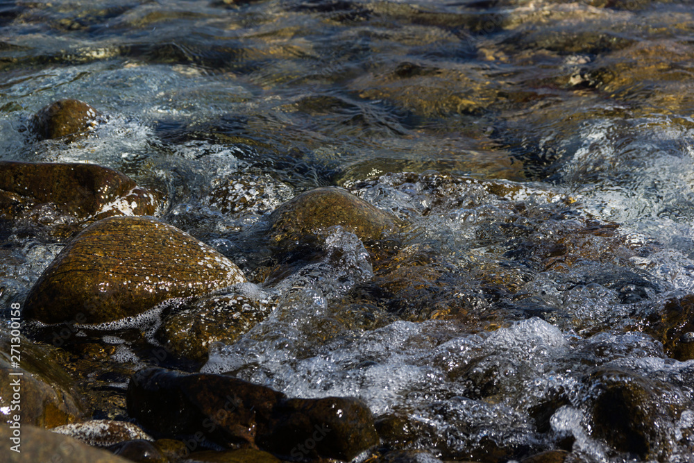 Smooth stones in the wave of the Sea, background