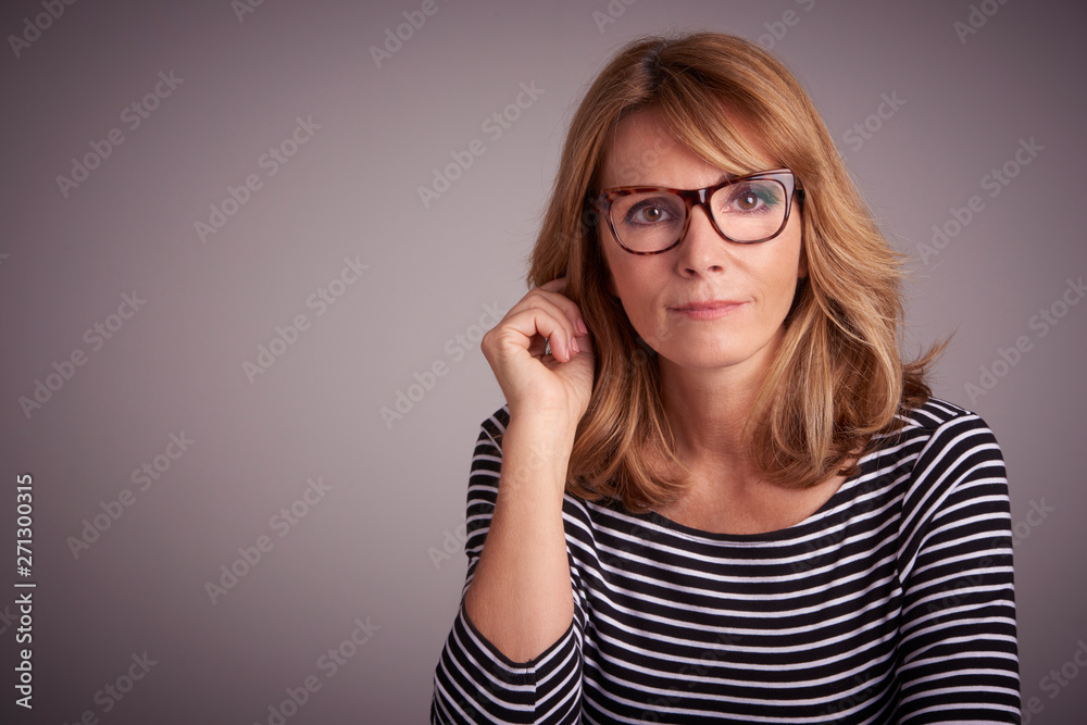 Confident middle aged woman studio portrait