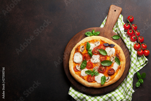 Photography Italian pizza with tomatoes, mozzarella and basil