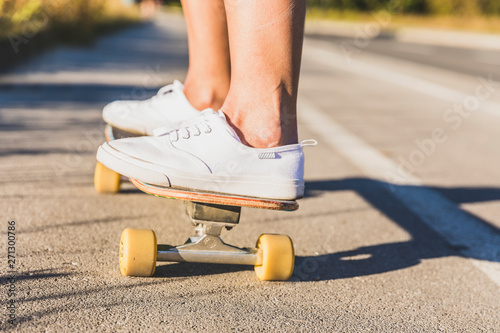 Close up of young woman's legs skateboarding