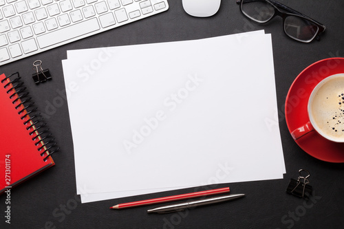 Office workplace table with blank paper page