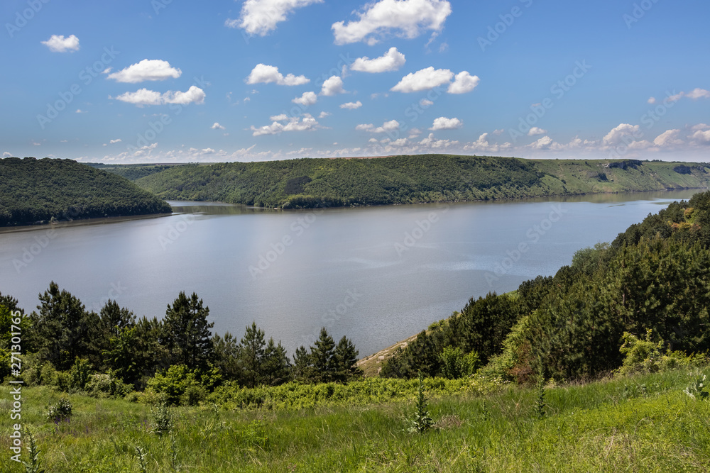 A sunny day on a high hill near the Dniester River, from which you can see the river and its tributary. Summer landscape. Ukraine.