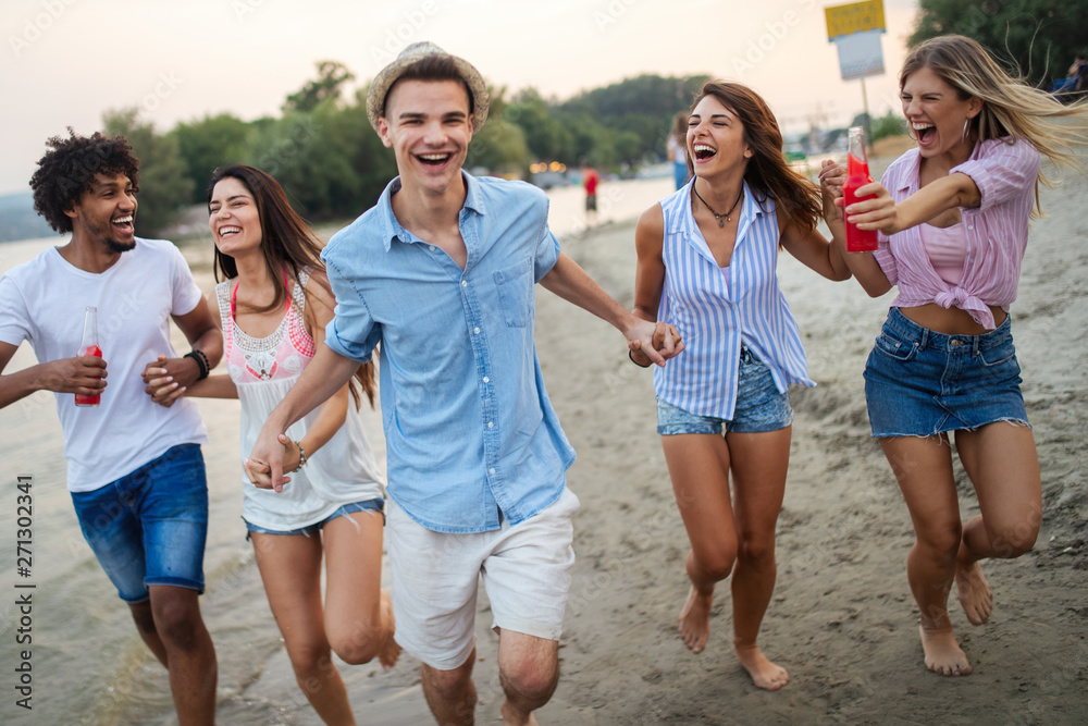 Multiracial group of friends enjoying a day at beach. Multiracial group of friends enjoying a day at beach.