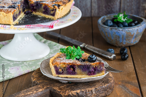 Blueberry and almond tart dusted with icing sugar