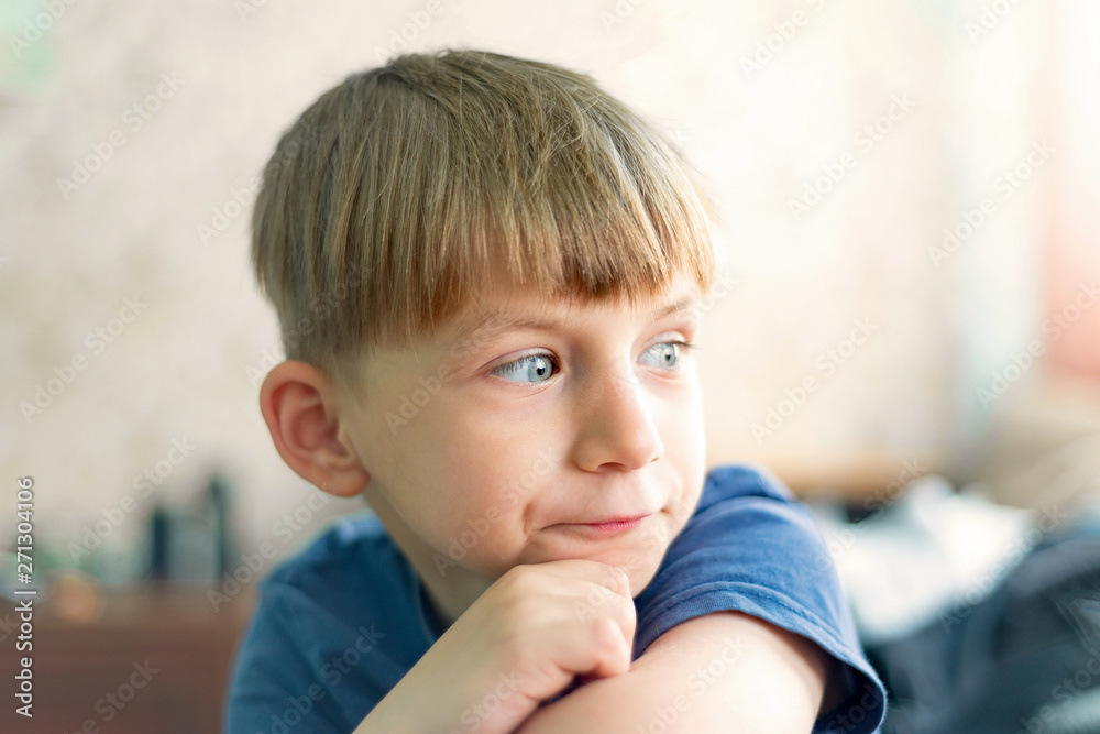 A portrait of a cute and intelligent little boy who is thinking and looking away. A portrait of a cute and intelligent little boy who is thinking and looking away.