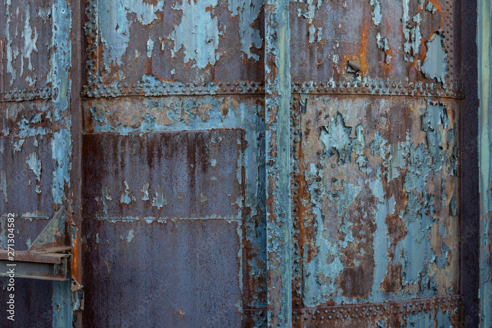 Creative industrial background with rusty metal, rivets, and peeling paint patinas, horizontal aspect Creative industrial background with rusty metal, rivets, and peeling paint patinas, horizontal aspect