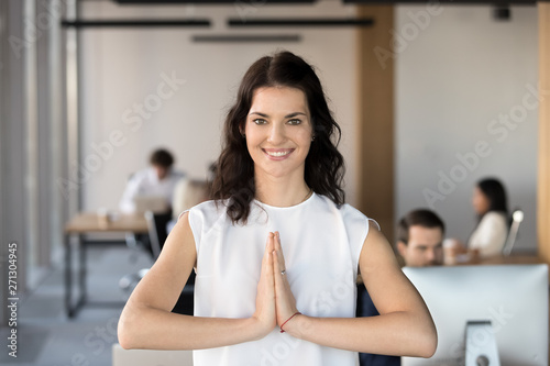 Portrait of smiling female employee meditate in prayer pose Free Download Portrait of smiling female employee meditate in prayer pose - GFXLoad