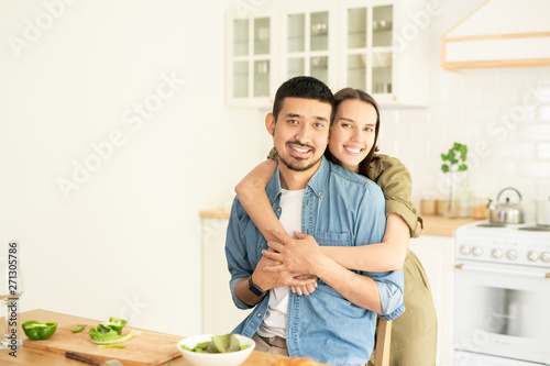 Embracing in the kitchen