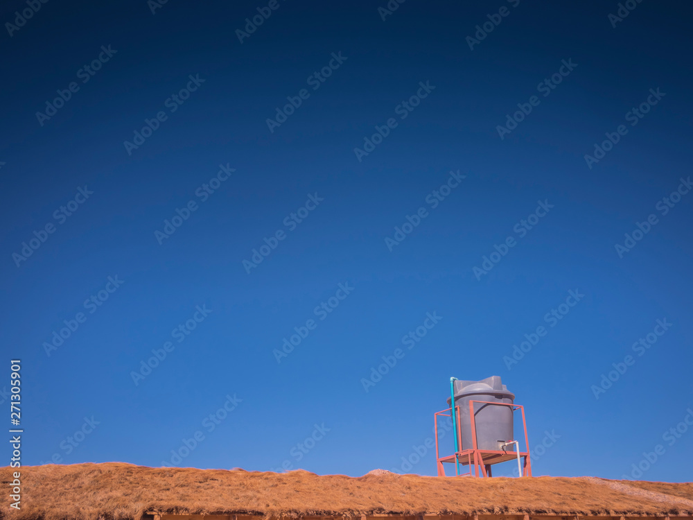 Obraz premium Environmental issues highlighting water supply with image of Water Tank On Roof In Sun