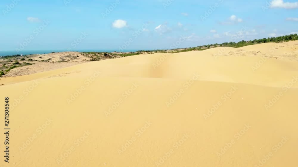 Drone flying over white sandy dunes, sunny day. Mui Ne, Vietnam. Drone flying over white sandy dunes, sunny day. Mui Ne, Vietnam.
