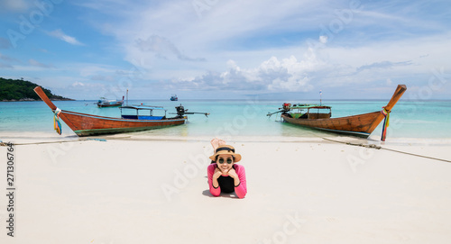 Women lie on the beach and the sea have a holiday summer relaxing and travel bright sky koh lipe thailand