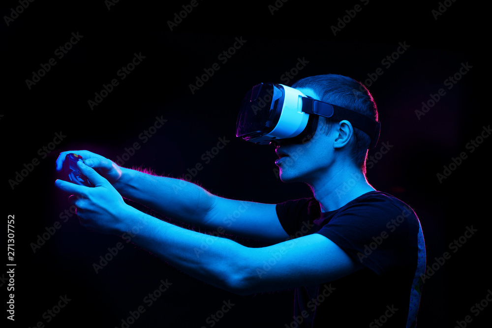 Man with virtual reality headset is playing game.