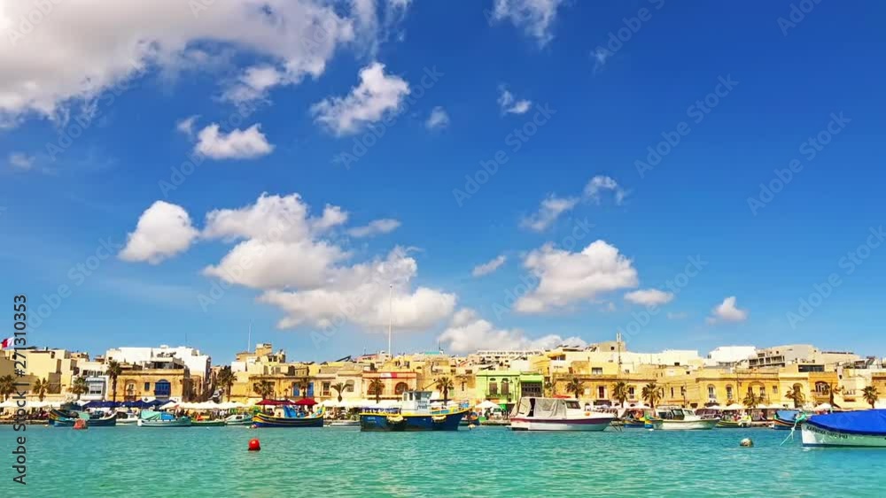 Aerial view on the mediterranean traditional colorful boats Luzzu. Fisherman village in the south east of Malta. Sunny day in Marsaxlokk, Malta.