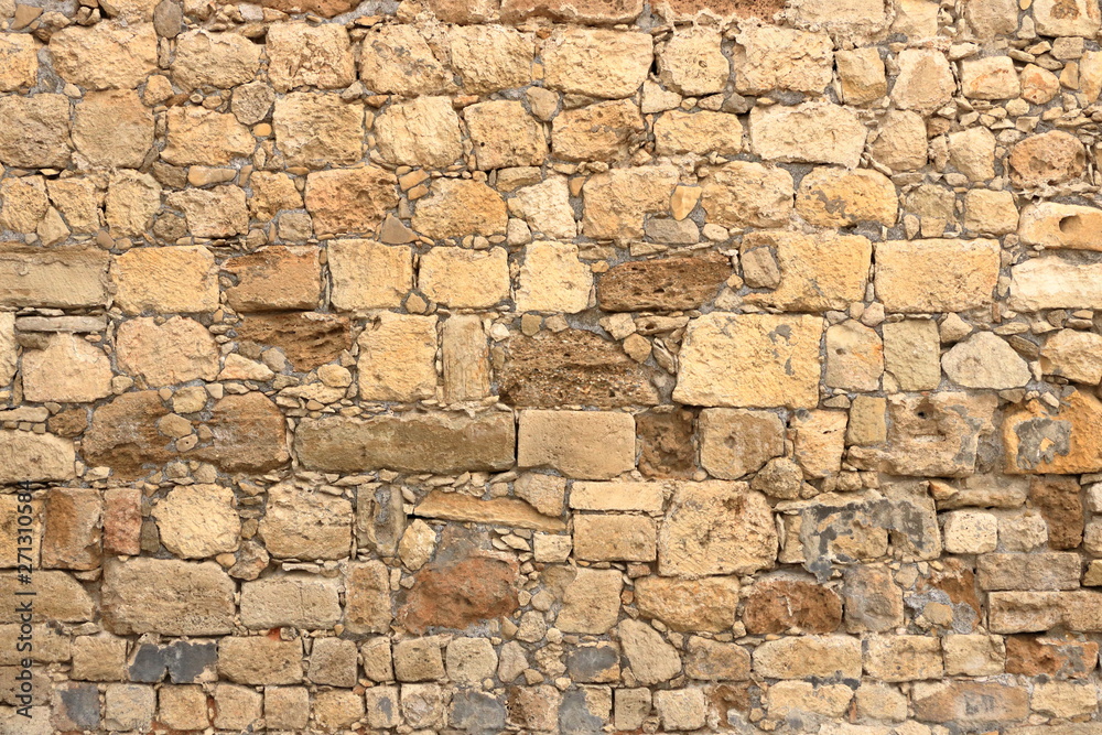 Fototapeta premium Big yellow wall from stone bricks