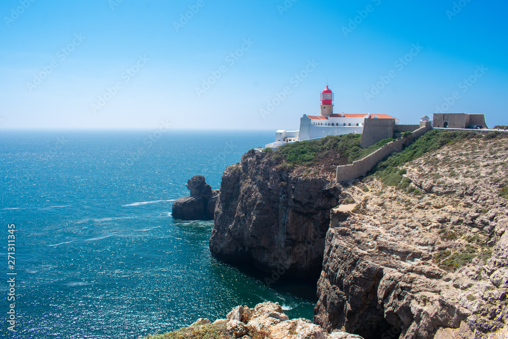 Lighthouse on cliff in Sagres, Algarve. West Coast of Atlantic Ocean in Portugal