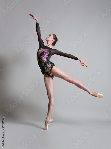 Beautiful ballerina in pointe shoes and colorful clothes posing. 
