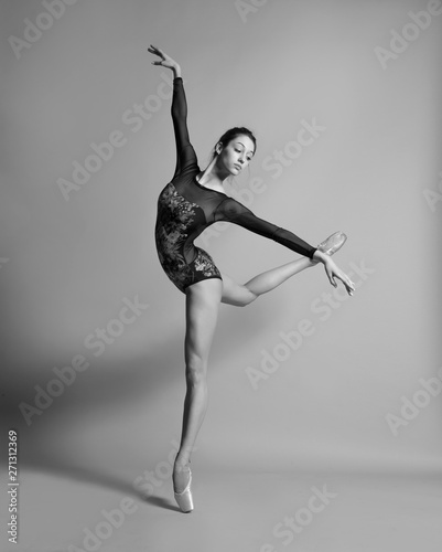 Beautiful ballerina in pointe shoes and colorful clothes posing. Black and white photo. © Yevgeniy