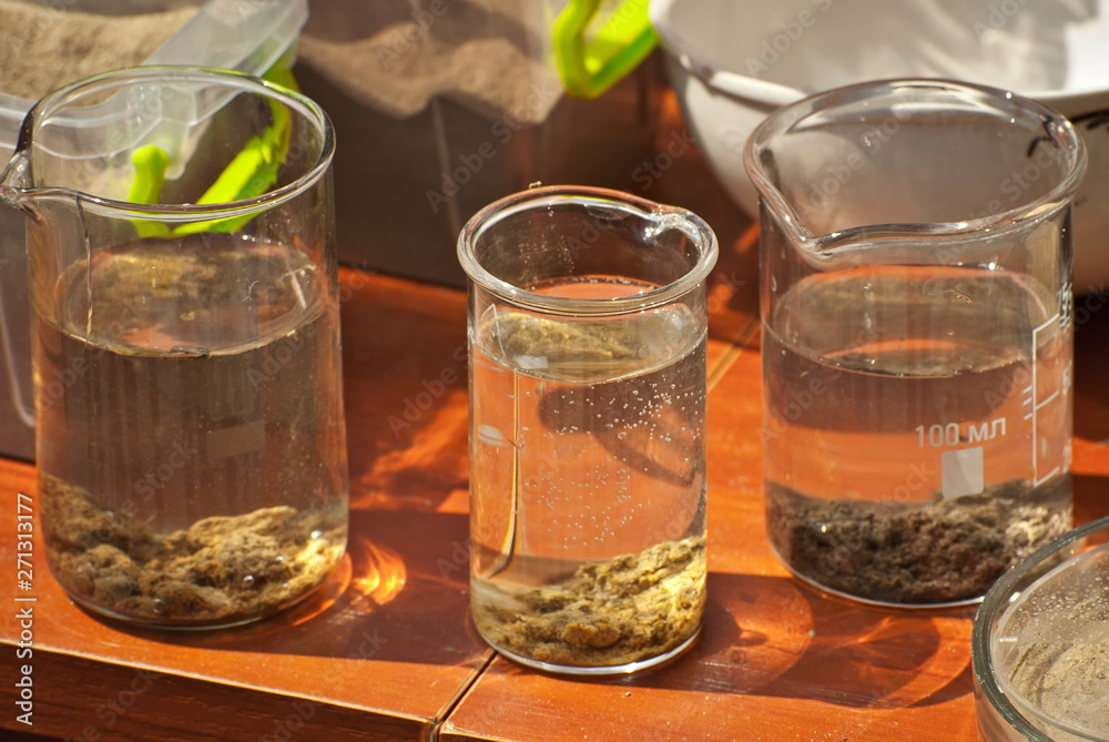 Soil experiments at the scientific fair. Test tubes with soil samples. An overview of the blurring of rocks by groundwaters. Soil experiments at the scientific fair. Test tubes with soil samples. An overview of the blurring of rocks by groundwaters.