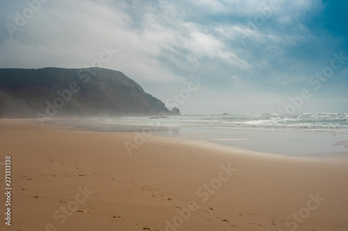 Fototapeta Naklejka Na Ścianę i Meble -  Rock formations and cliffs on beach, high waves on water of Atlantic Ocean. West coast of Algarve Portugal