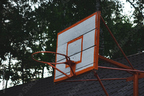 red basketball hoop in the woods.