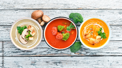 Variety of colorful vegetables cream soups. Concept of healthy eating or vegetarian food. Top view. Free copy space.