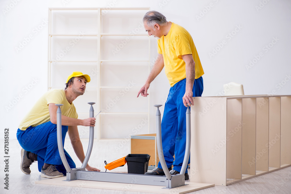 Two contractors carpenters working indoors Two contractors carpenters working indoors