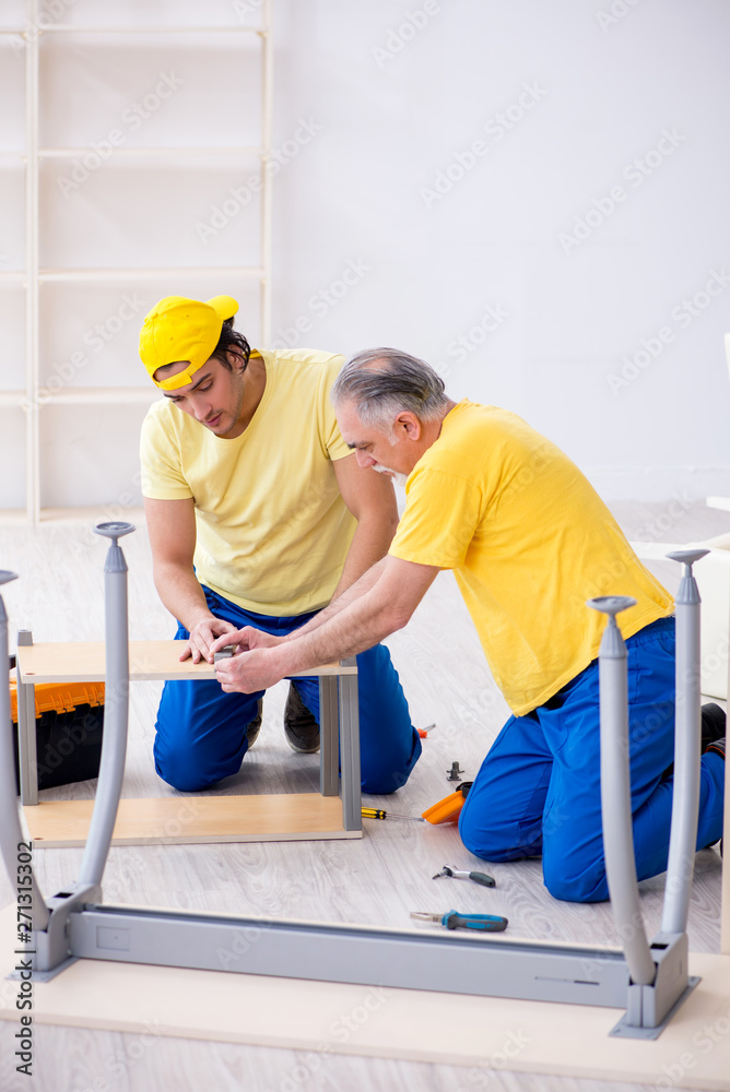 Two contractors carpenters working indoors Two contractors carpenters working indoors
