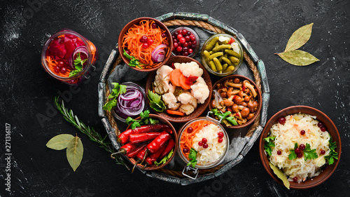 Stuffed vegetables and mushrooms on the kitchen table. Cabbage, mushrooms, cucumbers, cauliflower. Top view. Free space for your text.