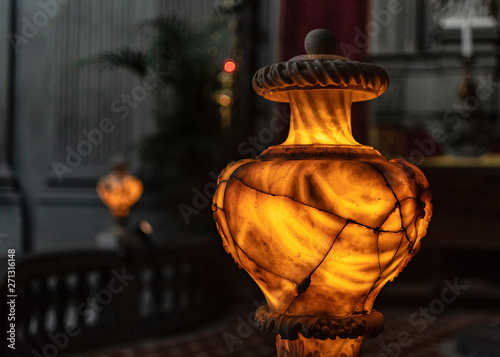 Photos ancient illuminated alabaster vase shows the face of Medusa and numerous cracks